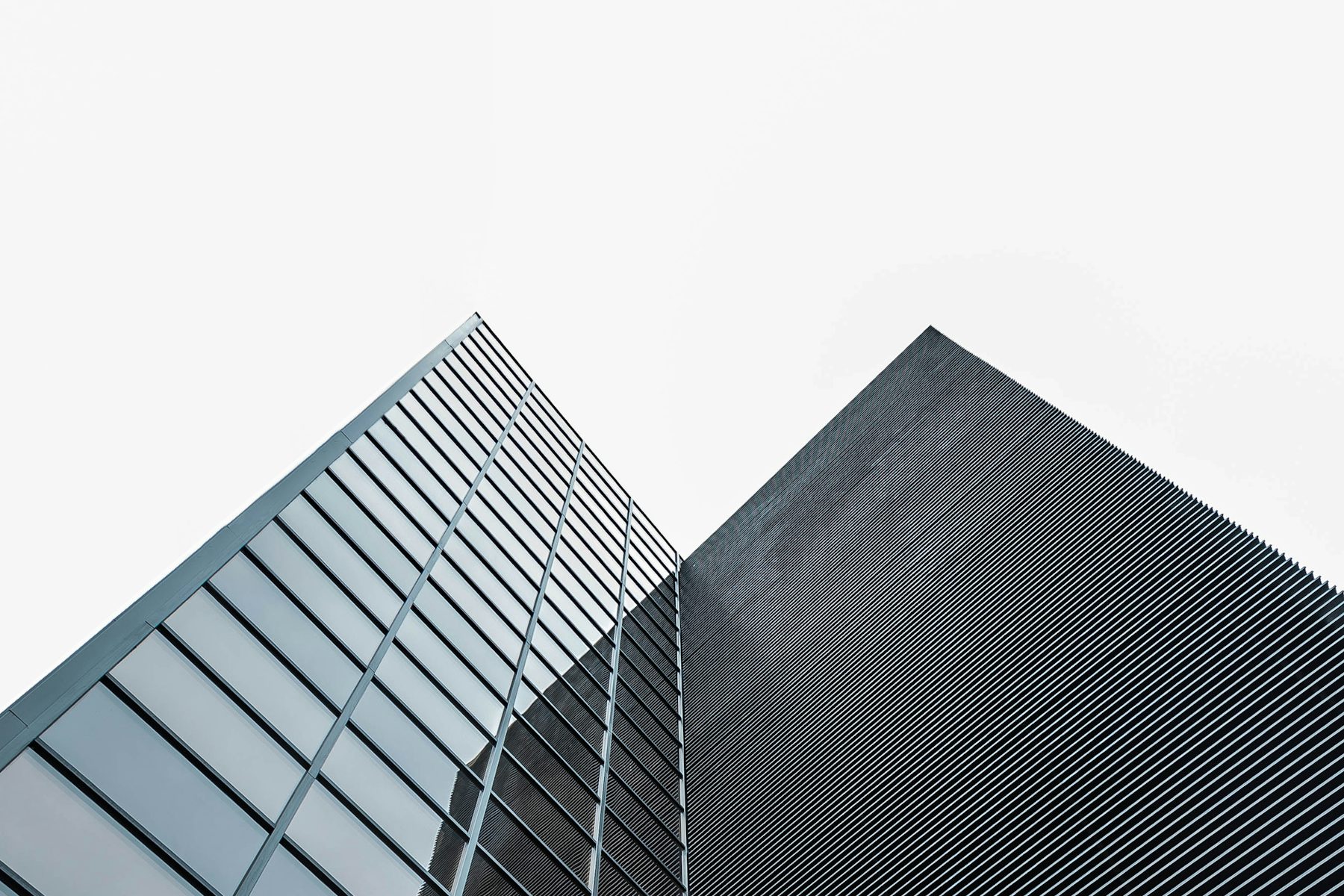 Low-angle view of a modern glass and steel building in Madrid